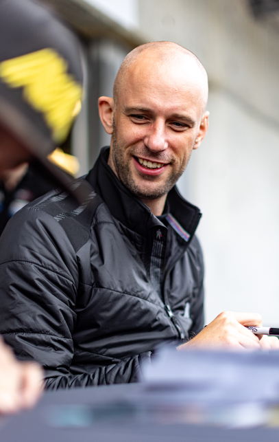 Matt Bell smiling signing autographs